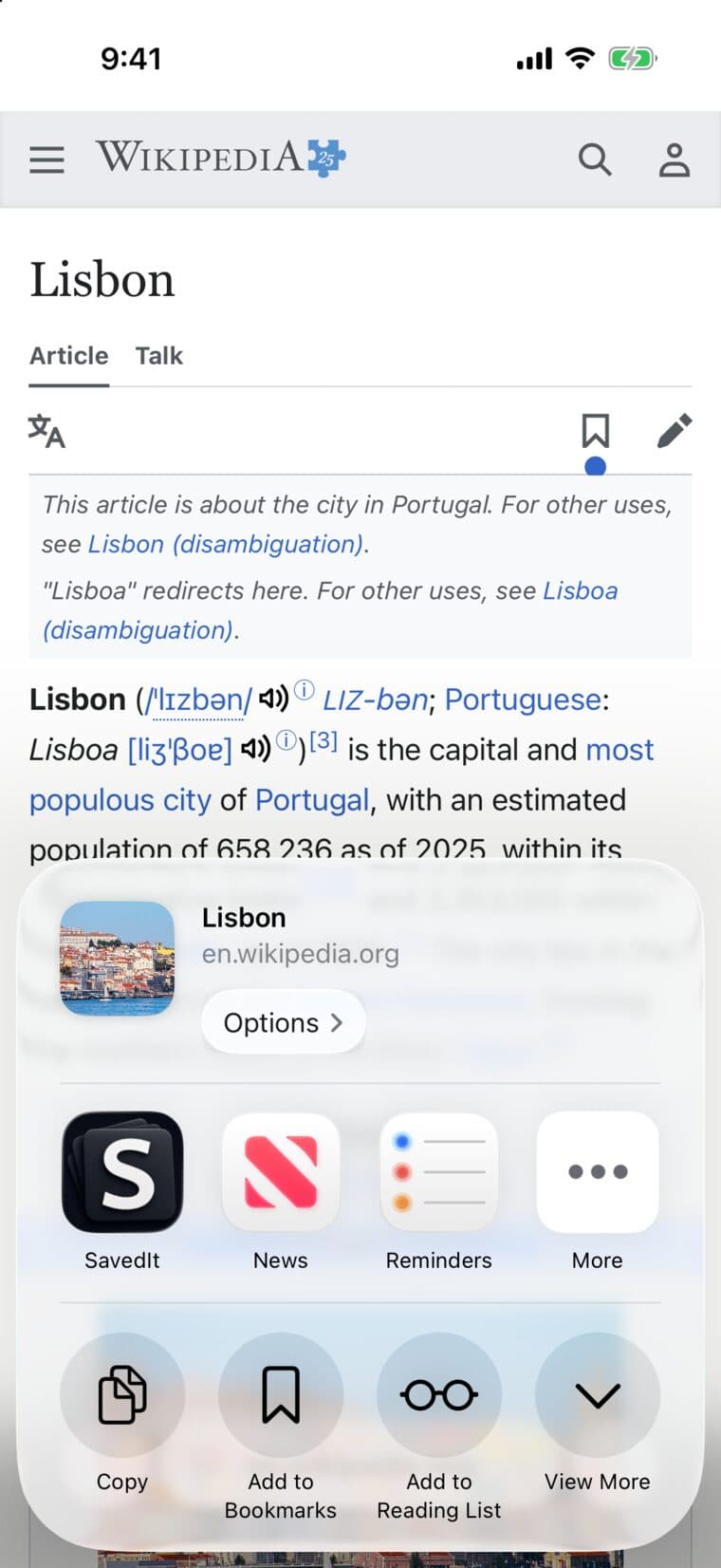 The iPhone share menu over a Wikipedia page about Lisbon, with SavedIt first in the row of apps