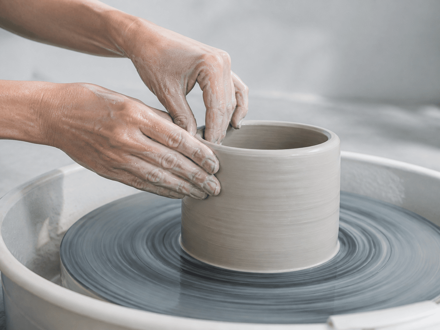 Hands shaping pottery saved from a web article